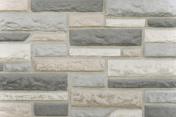 Old grey stone mosaic wall background texture