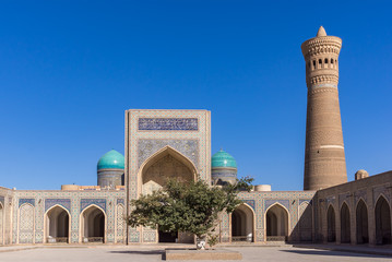 Fototapeta na wymiar Courtyard at Po-i-Kalyan, with the madrasa and minaret - Bukhara, Uzbekistan. The complex include Kalyan four-iwan mosque and Kalyan minaret.