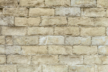 White old brick wall texture. Background of weathered, thawed and cracked silicate brick wall.