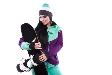 young beautiful woman in purple ski suit hold snowboard