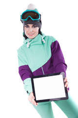 young pretty woman in purple ski costume and ski glasses hold empty tablet