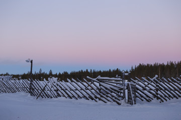 old vintage fence in winter in the village