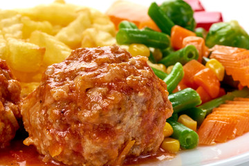 Meat ball in tomato sauce with potatoes fries, close-up, isolated on white background