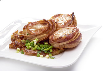 Pork fillet wrapped in bacon, isolated on white background