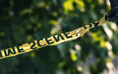 Crime scene tape closeup, police tape Do Not Cross outdoors