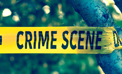 Crime scene tape closeup, police tape Do Not Cross outdoors
