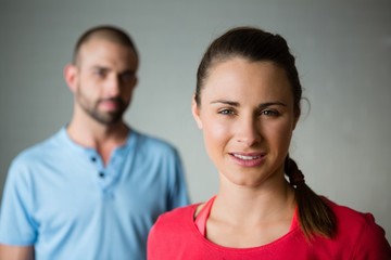Portrait of student with instructor standing in yoga studio