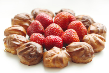 Strawberry with profiteroles on a white background