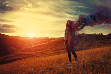 Young woman looking at the sunrise