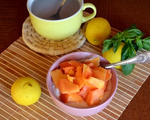 Chopped ripe papaya and cottage cheese on a bowl. Delicious breakfast.