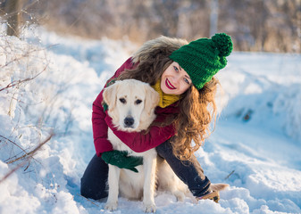 Close up happy woman owner and white golden retriever dog in winter day