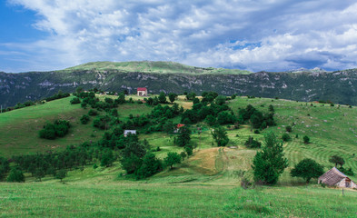 Fototapeta na wymiar Fields, meadows, mountains, roads. Balkans. An aerial top-view
