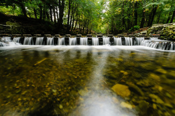 Water flowing between stepping stones on the Shimna River, Tollymore Forest, Northern Ireland, featured in Game of Thrones