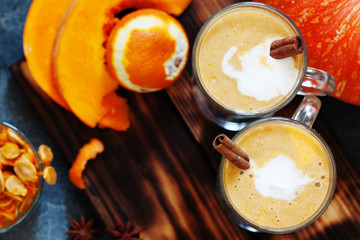 Pumpkin spice latte, hot coffee drink with pumpkin and cinnamon top view