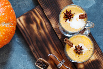 Pumpkin spice latte, hot coffee drink with pumpkin and cinnamon top view