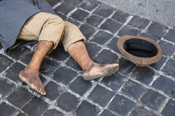 Homeless beggar lies on the street