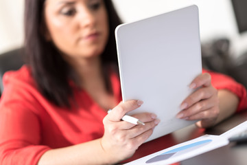 Fototapeta premium Young attractive businesswoman using a tablet