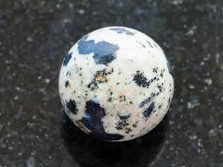 bead from Dalmatian Jasper gemstone on dark