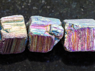 beads from iridescent pyrite gemstone on dark