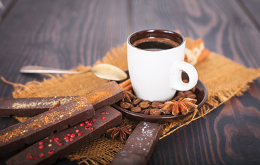 A cup of coffee and chocolate with spices.