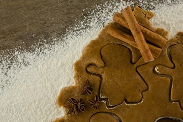 Gingerbread dough with flour, cookie cutter, anise and cinnamon