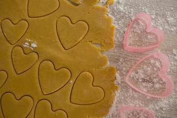 Raw cookie dough with heart shaped cookie cutter