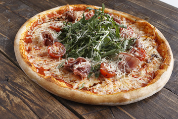 Big pizza on a wooden surface. Selective focus