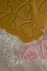 Raw cookie dough with heart shaped cookie cutter