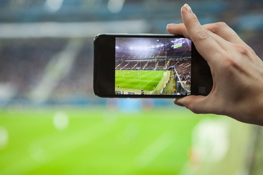 Football fan removes the football game on mobile smartphone