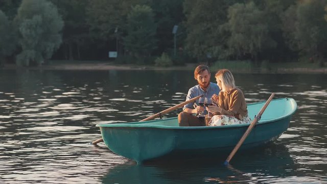 Couple in boat at sunset