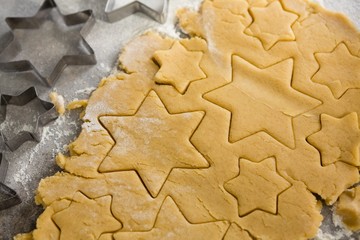 Raw cookie dough with star shape and cutter