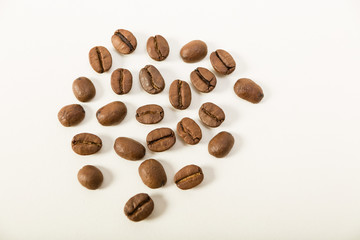 macro image of dark aromatic coffee beans  on   white background with  copy space.