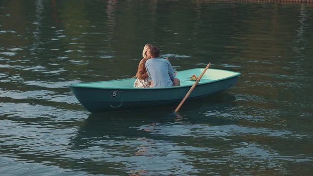 Kissing young couple in a boat
