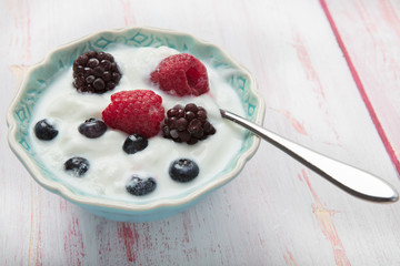 Healthy homemade  yogurt bowl with fresh blueberries, raspberries and blackberries