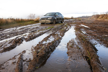 The real off-road against the background of a blurry car in the rain