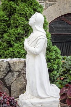 Close up image of a Shepherd Child praying to the Blessed Mother Mary, Our Lady of Fatima at the Shrine of Saint Anthony Church in Soho.