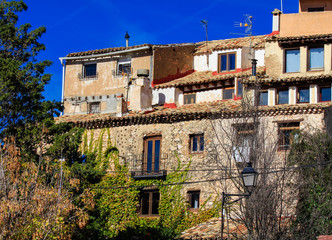 Fototapeta na wymiar Bright colorful picture of old spanish buildings in Cuenca, blue sky, sunny day