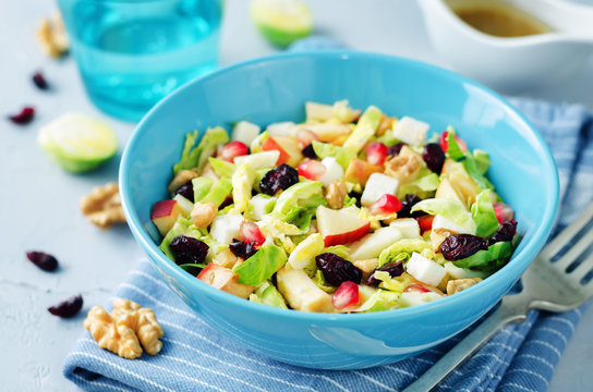 Shredded brussel sprout apple dried cranberry walnuts salad