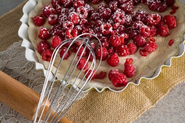 Red berries on tart with whisker 