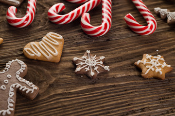 Chrismas cookies, candy canes on wooden background. Holiday mood. Top view.