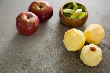 Peeled green apple and two red apple