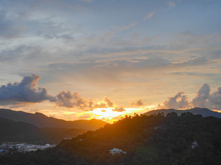 Sunset behind mountain There is a beautiful evening sunlight cloudy sky , look  from the view point on the mountain in downtown.