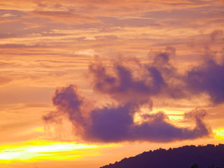 Twilight beautiful evening cloudy sky  after sunset background . There are silhouette mountains and trees.