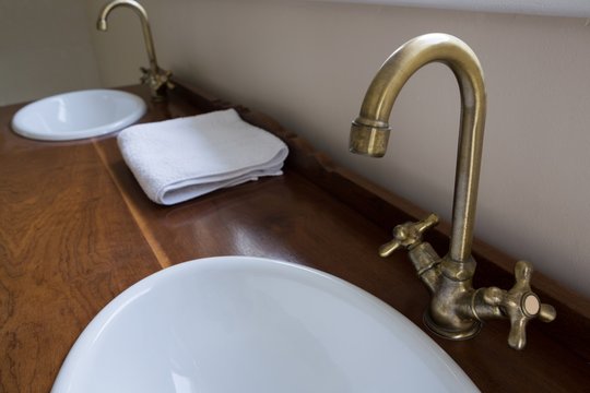 Sinks with steel taps installed on marble platform
