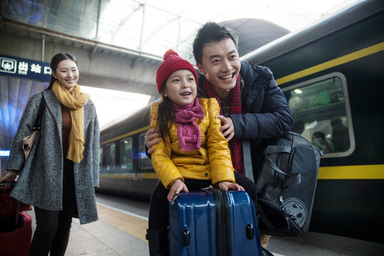 Happy family at the station platform