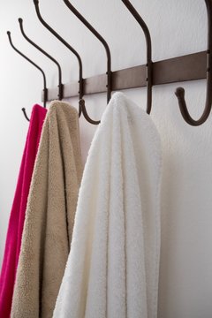 Close-up of colorful towels hanging on hook