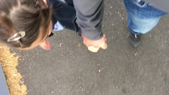 POV (point of view) of a father walking with his daughter (age 07) together to primary school. Family life concept. Real people
