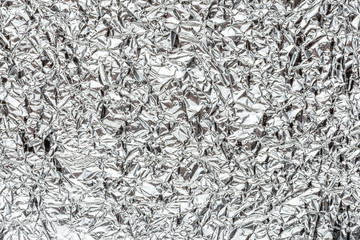 Abstract shiny crumpled silver metal chrome aluminum foil background texture