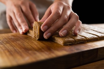 Woman arranging dough on chopping board