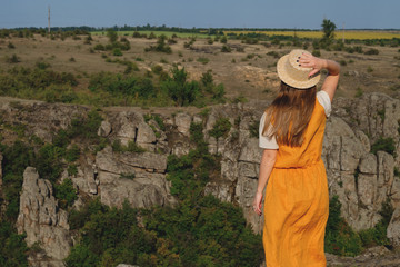 happy girl standing on a background of the canyon